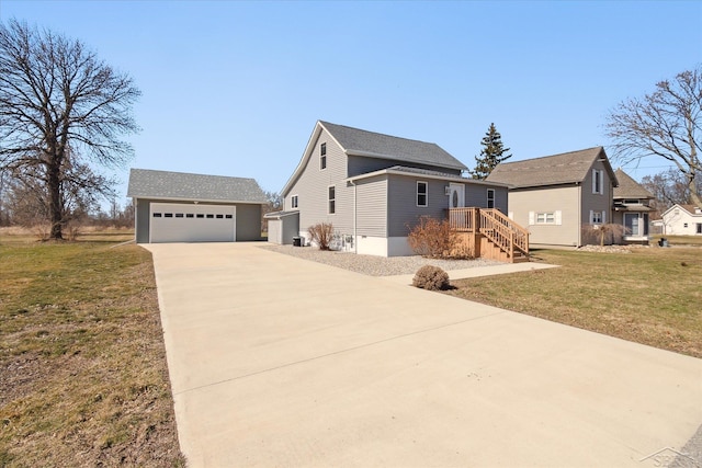 view of front of house with an outdoor structure, a garage, and a front lawn