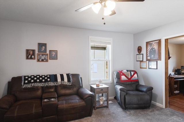 carpeted living room with a ceiling fan and baseboards