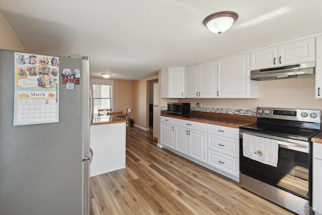 kitchen featuring light wood-style flooring, appliances with stainless steel finishes, under cabinet range hood, white cabinetry, and dark countertops