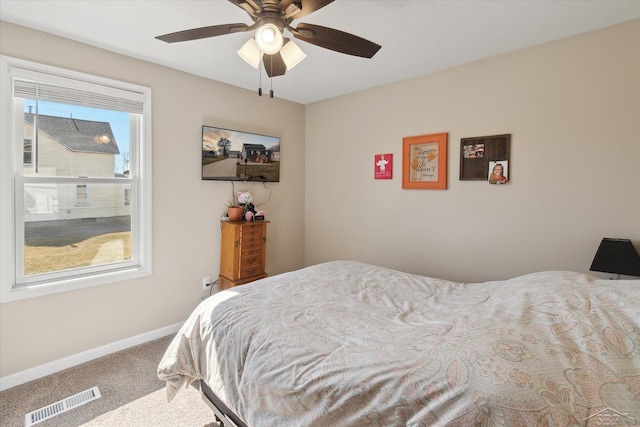 carpeted bedroom with baseboards, visible vents, and ceiling fan