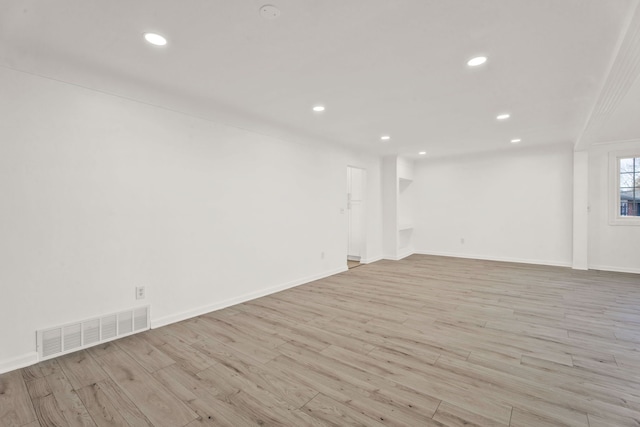 unfurnished room with recessed lighting, visible vents, baseboards, and wood finished floors