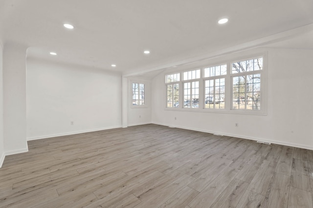 unfurnished room with recessed lighting, wood finished floors, and baseboards