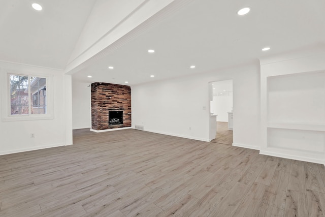 unfurnished living room featuring baseboards, visible vents, recessed lighting, light wood-style floors, and a large fireplace