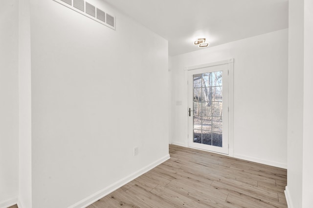 unfurnished dining area featuring visible vents, baseboards, and wood finished floors