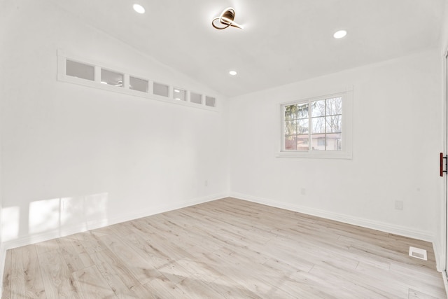 spare room featuring recessed lighting, visible vents, wood finished floors, and vaulted ceiling