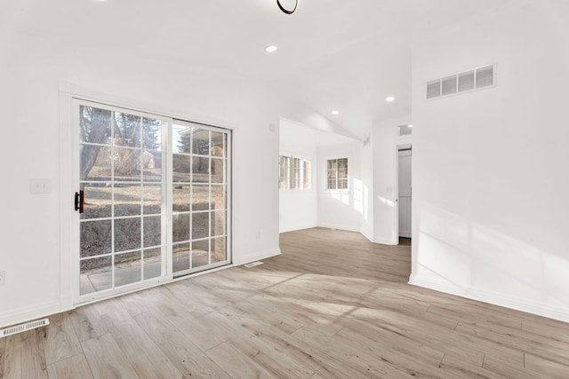 unfurnished room featuring recessed lighting, visible vents, wood finished floors, and vaulted ceiling