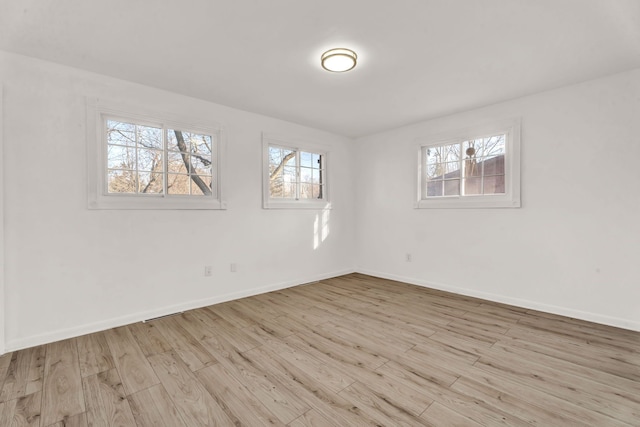 empty room with wood finished floors and baseboards