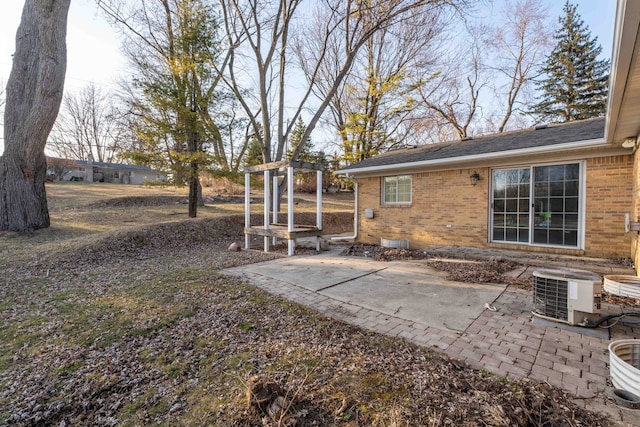 view of yard with central AC unit and a patio area