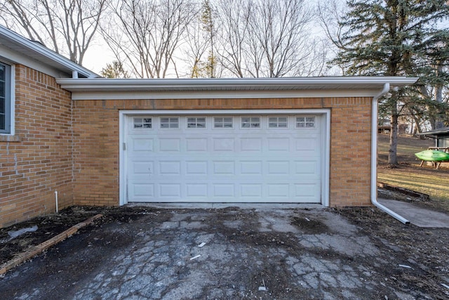 garage with aphalt driveway