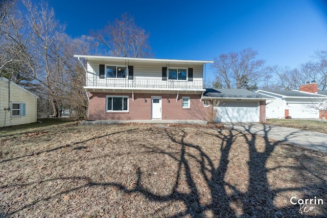 view of front of house featuring brick siding, a balcony, concrete driveway, and an attached garage