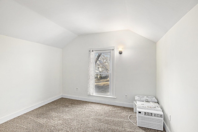 additional living space featuring baseboards, carpet, and vaulted ceiling