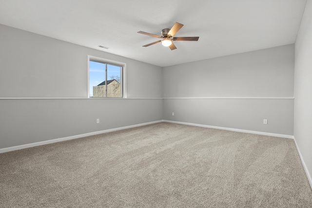 unfurnished room featuring baseboards, visible vents, carpet floors, and ceiling fan