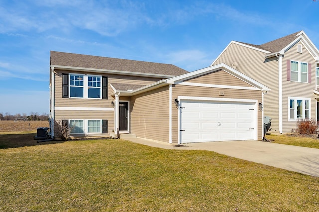 view of front facade featuring a front lawn, concrete driveway, a garage, and roof with shingles