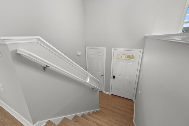 stairs featuring wood finished floors and baseboards