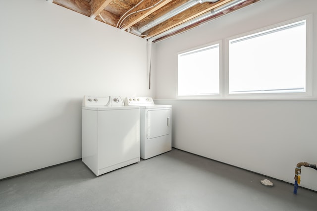 washroom featuring laundry area and separate washer and dryer