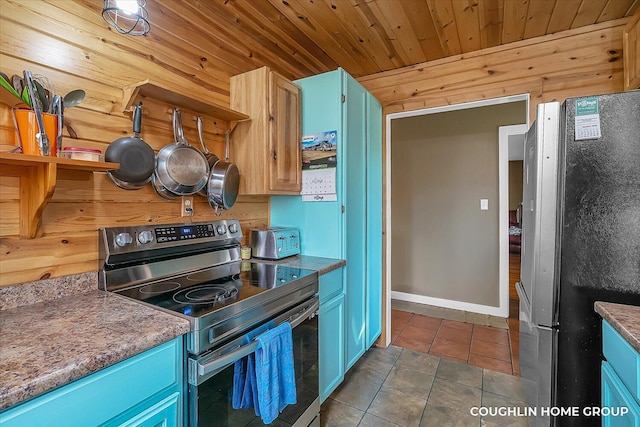 kitchen with blue cabinetry, stainless steel appliances, dark tile patterned flooring, and wood ceiling