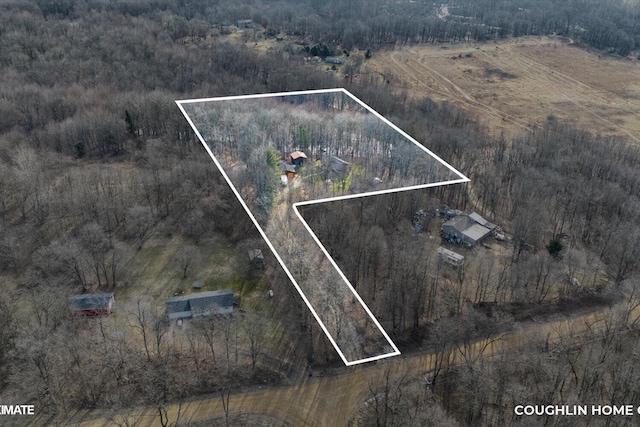 drone / aerial view featuring a rural view and a wooded view