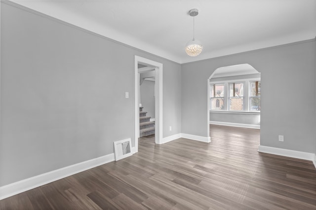 interior space featuring visible vents, stairway, arched walkways, baseboards, and dark wood-style flooring