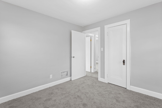 unfurnished bedroom with visible vents, baseboards, and carpet floors