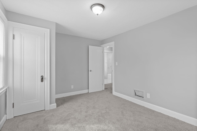 unfurnished bedroom featuring visible vents, baseboards, and carpet floors