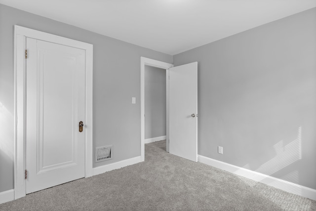 unfurnished bedroom with visible vents, baseboards, and carpet flooring