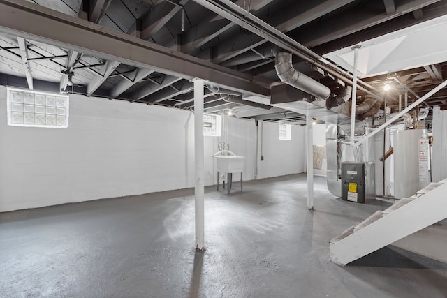 basement featuring water heater and heating unit