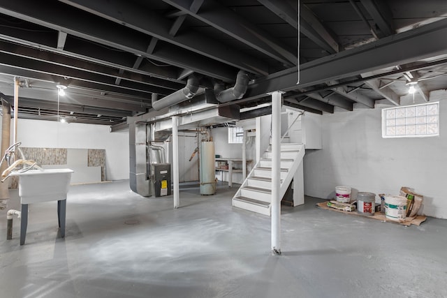 basement with stairway, heating unit, and water heater