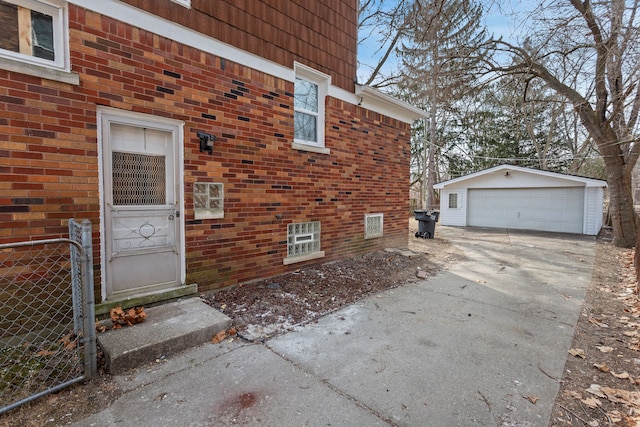 doorway to property with brick siding and a detached garage