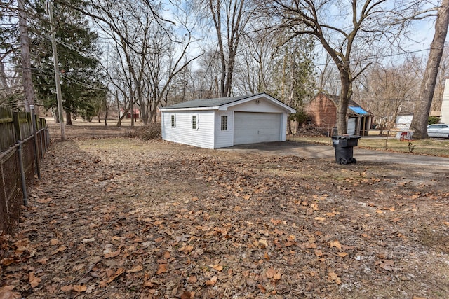 view of yard featuring an outdoor structure, fence, and a garage