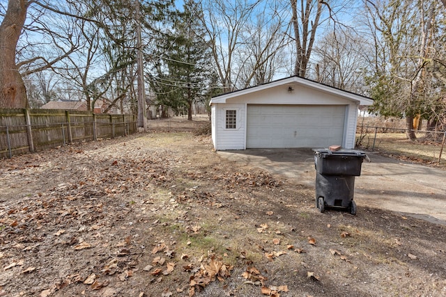 detached garage featuring fence