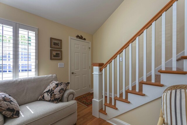 entryway with wood finished floors and stairs