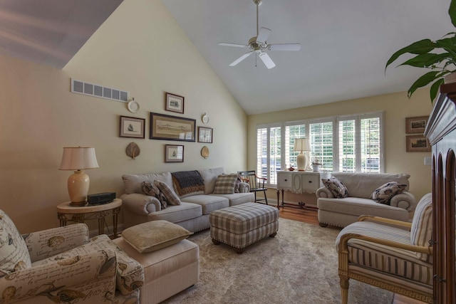 living area featuring visible vents, wood finished floors, high vaulted ceiling, and ceiling fan