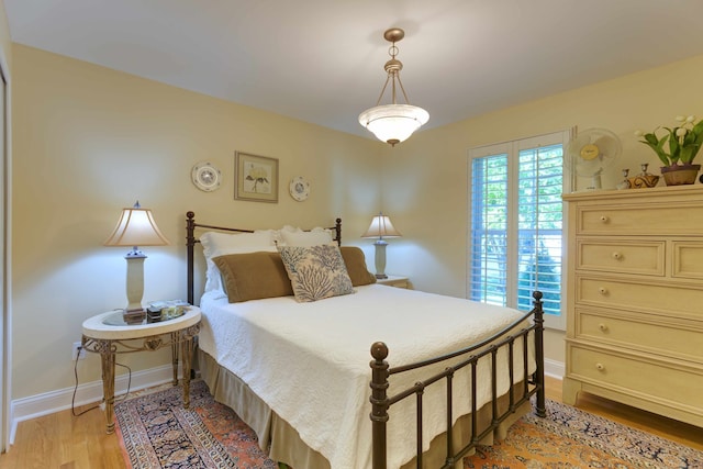 bedroom featuring light wood-type flooring and baseboards