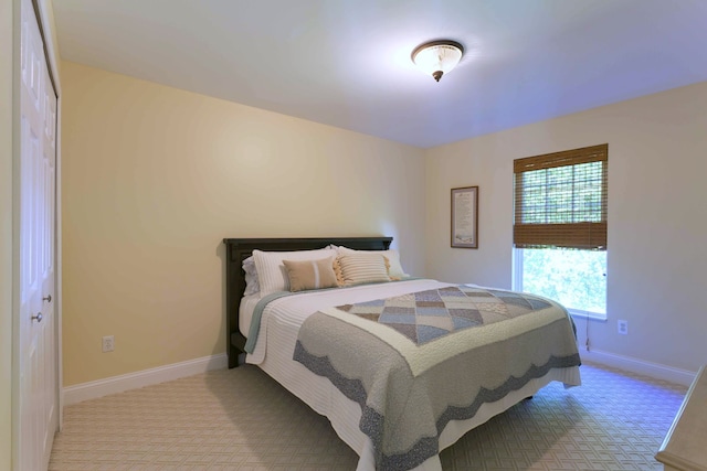 bedroom featuring carpet flooring and baseboards