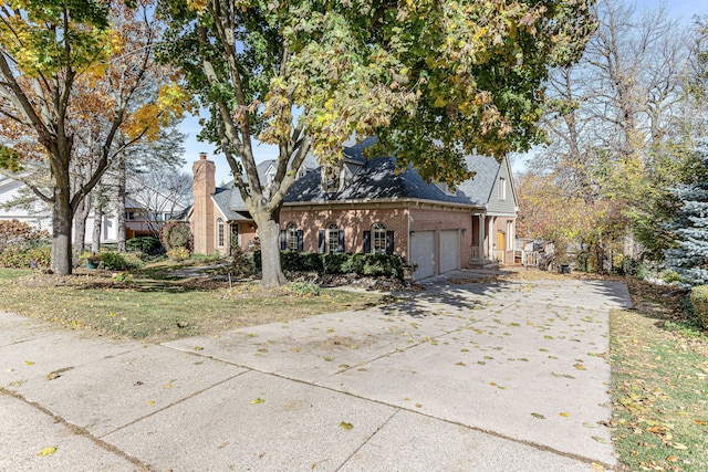 view of front of home featuring brick siding, concrete driveway, and a garage