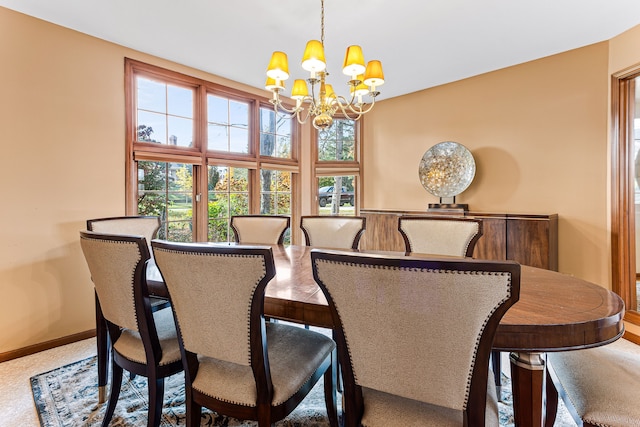 dining space featuring an inviting chandelier and baseboards