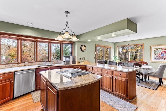 kitchen with a sink, a kitchen island, stainless steel dishwasher, light wood-style floors, and black electric cooktop