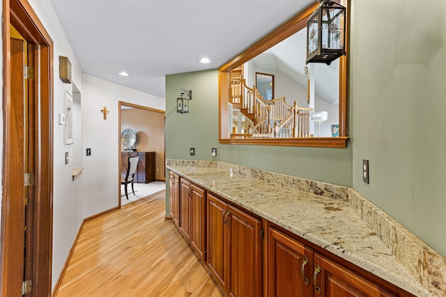 bathroom featuring recessed lighting, vanity, baseboards, and wood finished floors