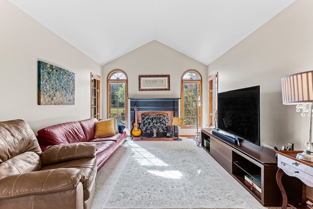 living area featuring vaulted ceiling, a fireplace, and carpet floors