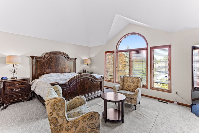 bedroom featuring vaulted ceiling, light colored carpet, baseboards, and visible vents