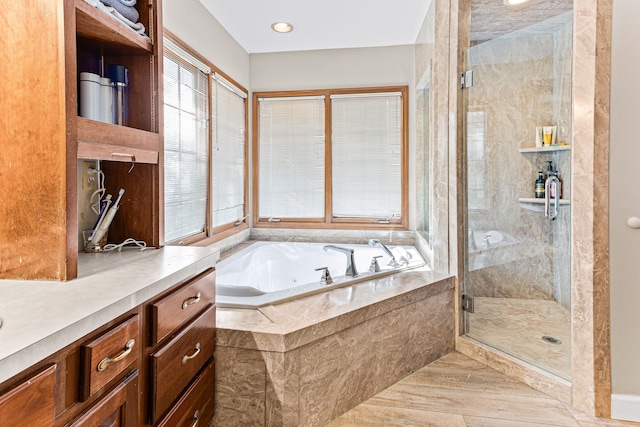 full bathroom with a wealth of natural light, a stall shower, and a whirlpool tub