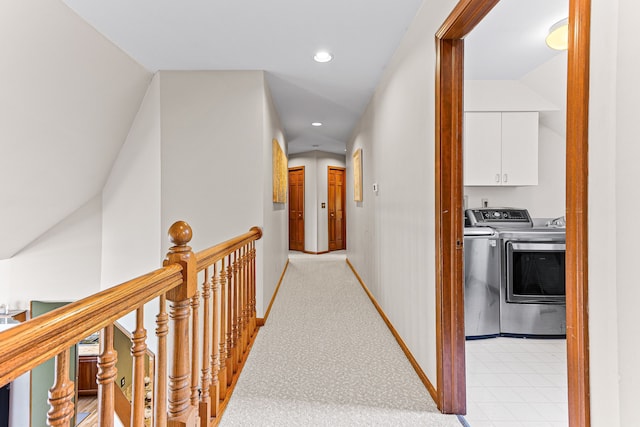 hall featuring recessed lighting, baseboards, an upstairs landing, and washer and clothes dryer