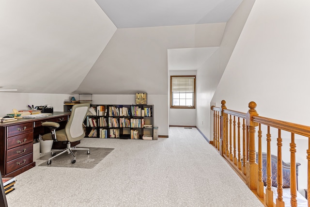 home office with baseboards, lofted ceiling, and carpet