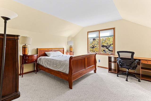 carpeted bedroom with baseboards and vaulted ceiling