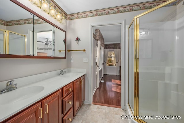 full bathroom with double vanity, a shower stall, and a sink