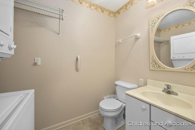 bathroom featuring vanity, toilet, and baseboards