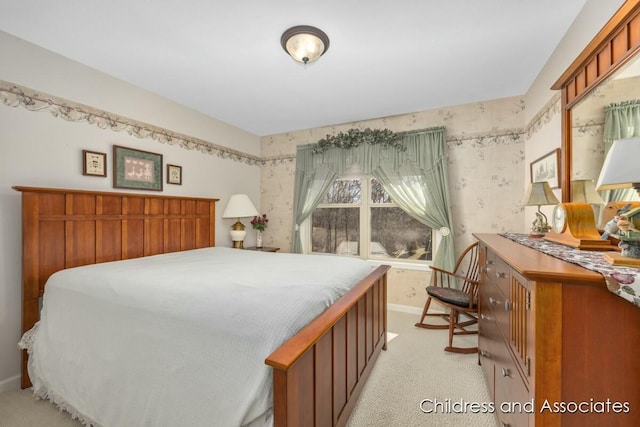 bedroom featuring wallpapered walls, baseboards, and light carpet