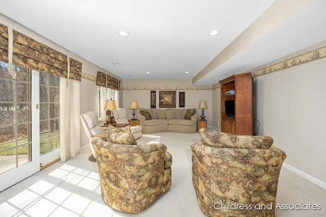 living area with recessed lighting, baseboards, and light colored carpet