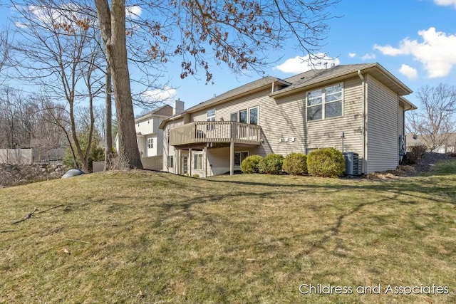 rear view of house with a wooden deck, central air condition unit, and a lawn