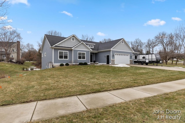 view of front of property with a garage, a front yard, board and batten siding, and driveway